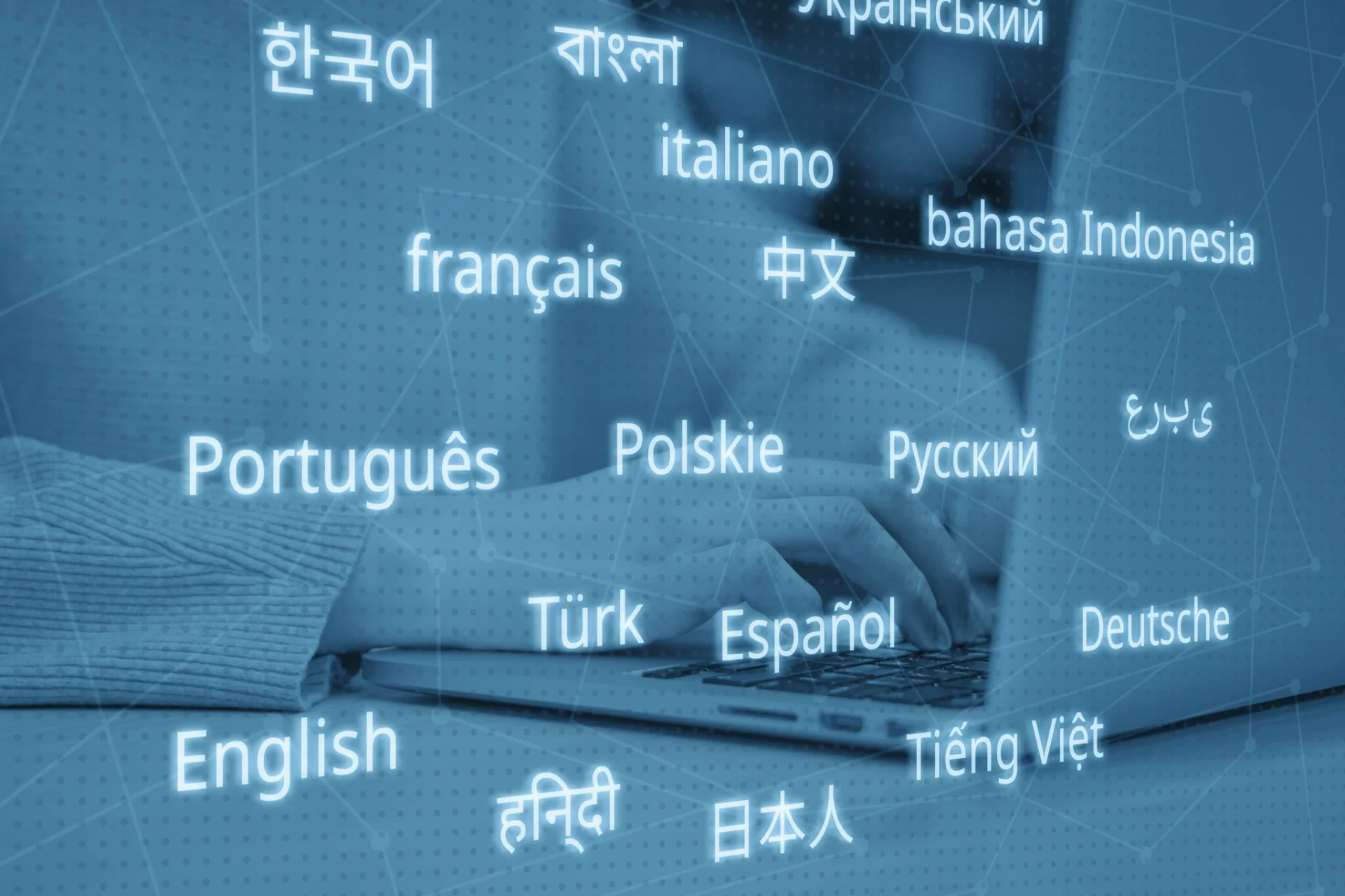Floating greetings in many languages over a laptop